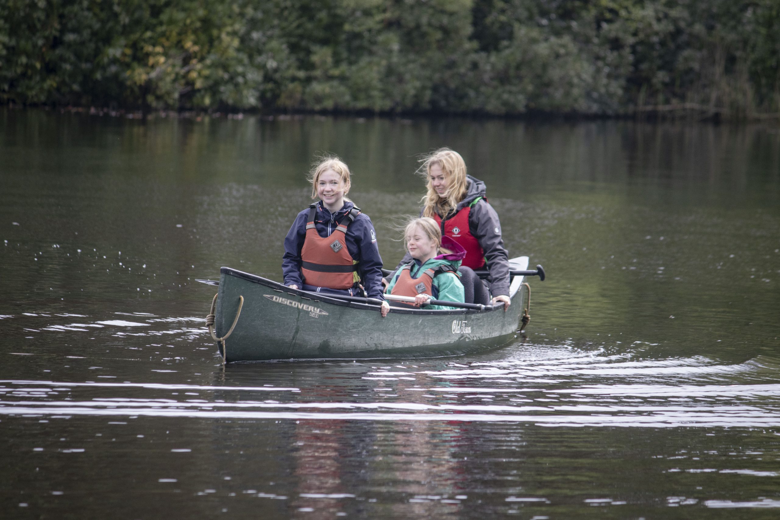 3 girls in kayak with one SEND girl on lake in the new forest