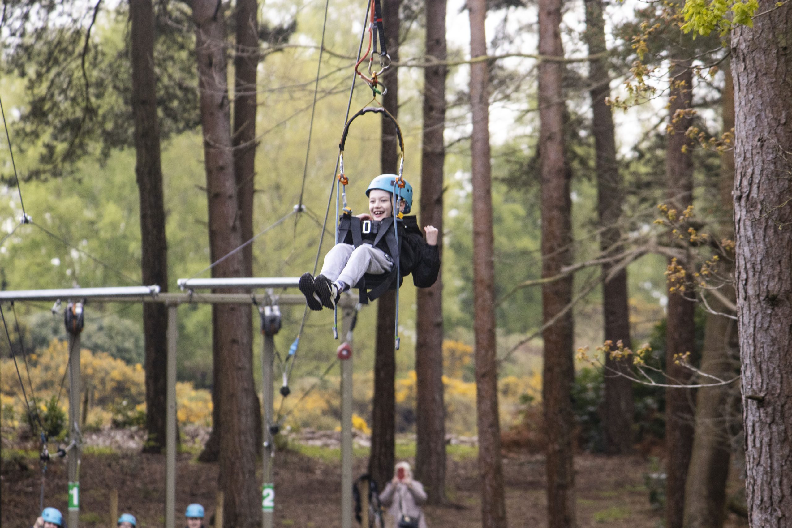 young boy on zip wire with specialised hoist and harness adapted for SEND needs