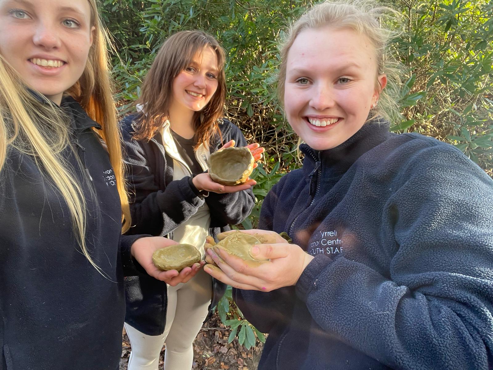 apprentices holding bowls they've made from nature in the New Forest at Avon Tyrrell Outdoor Centre