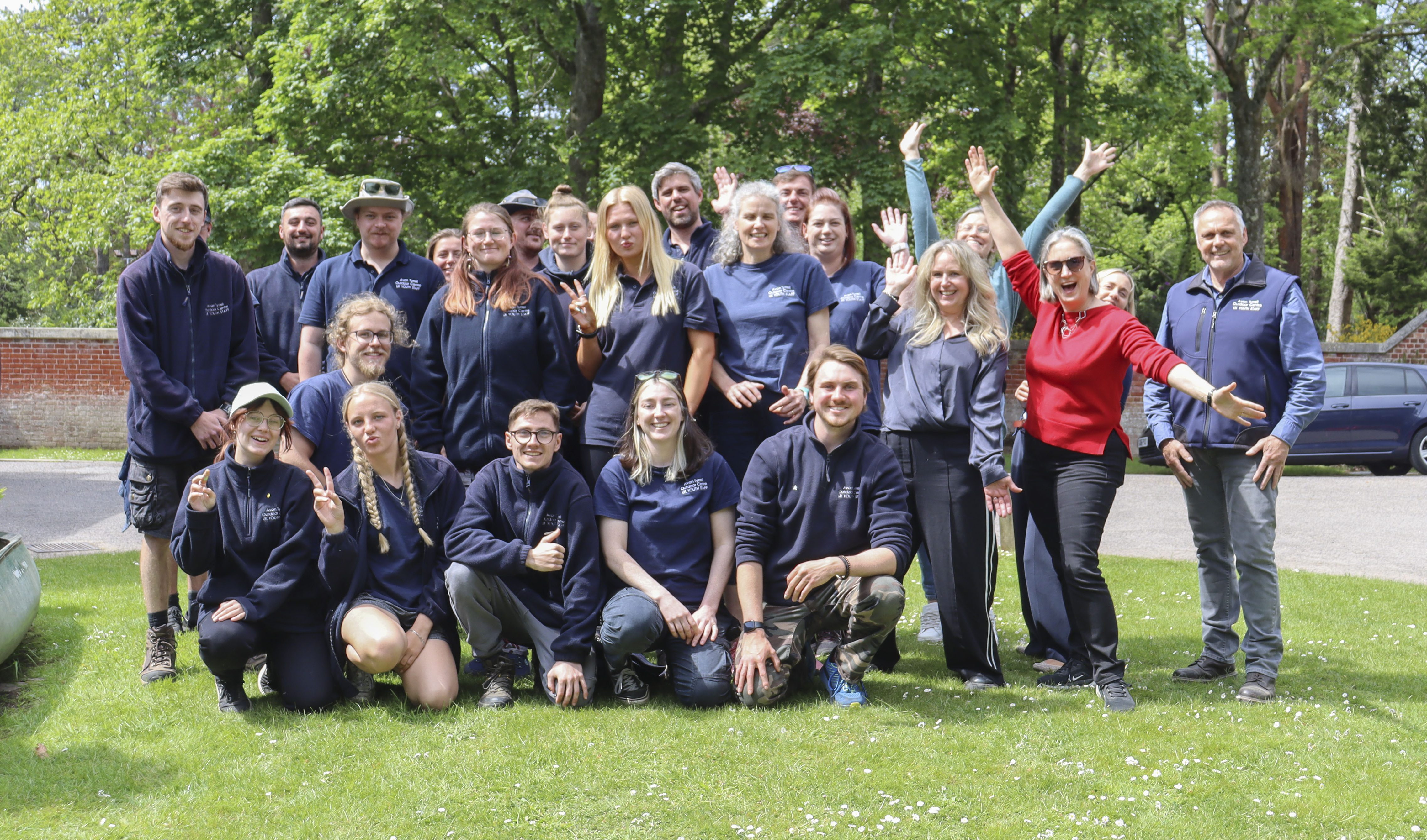 group of avon tyrrell staff outside of the manor house in the new forest